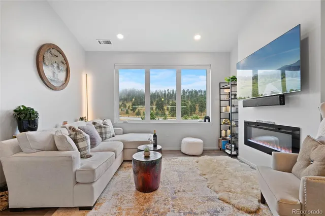 a living room with furniture a window and a fireplace