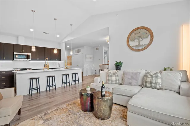 a living room with couches a dining table and chairs