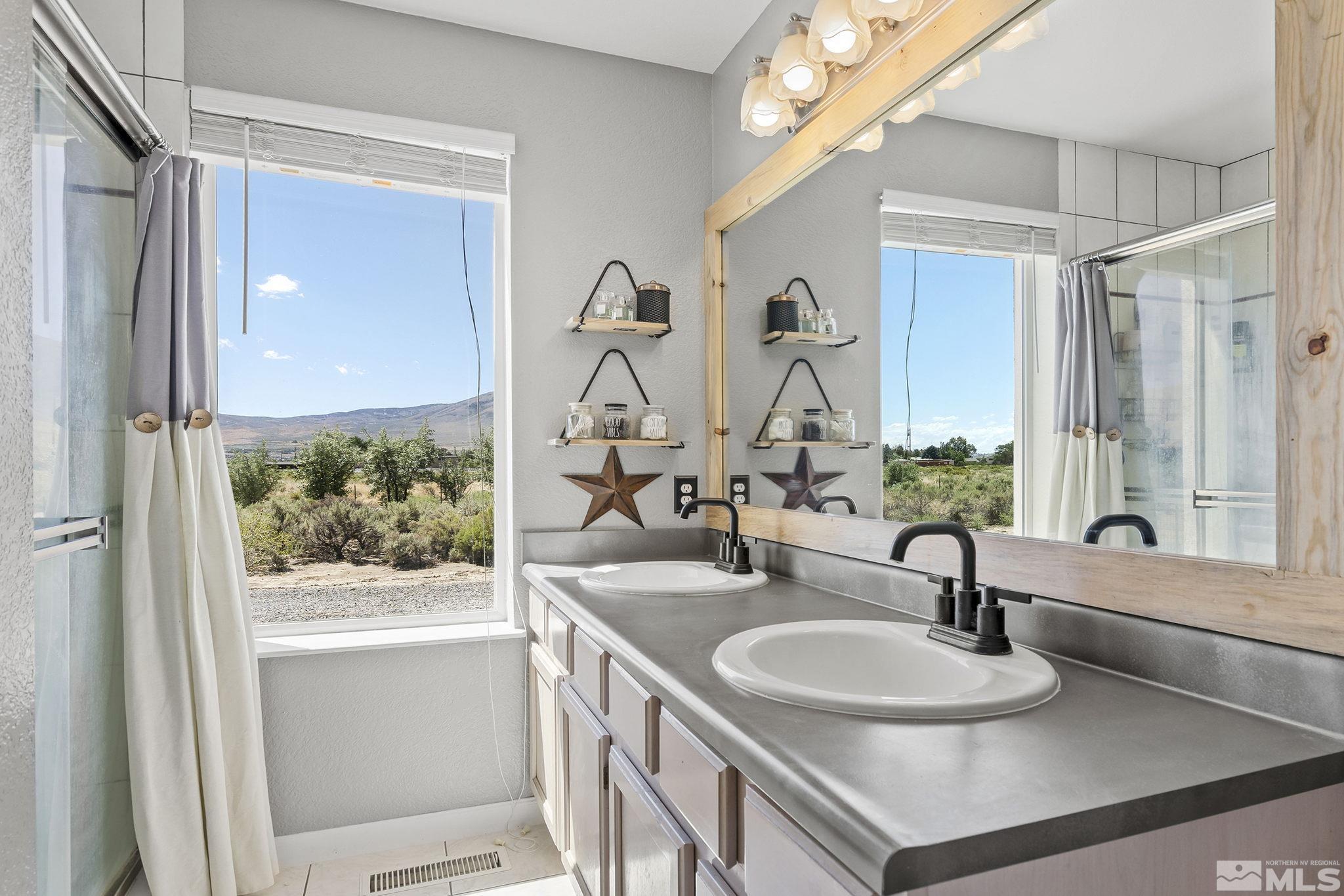 11090 Wagon Ho Lane Reno, NV 89508 - Photo 16 of 33 a bathroom with a sink double vanity and a mirror
