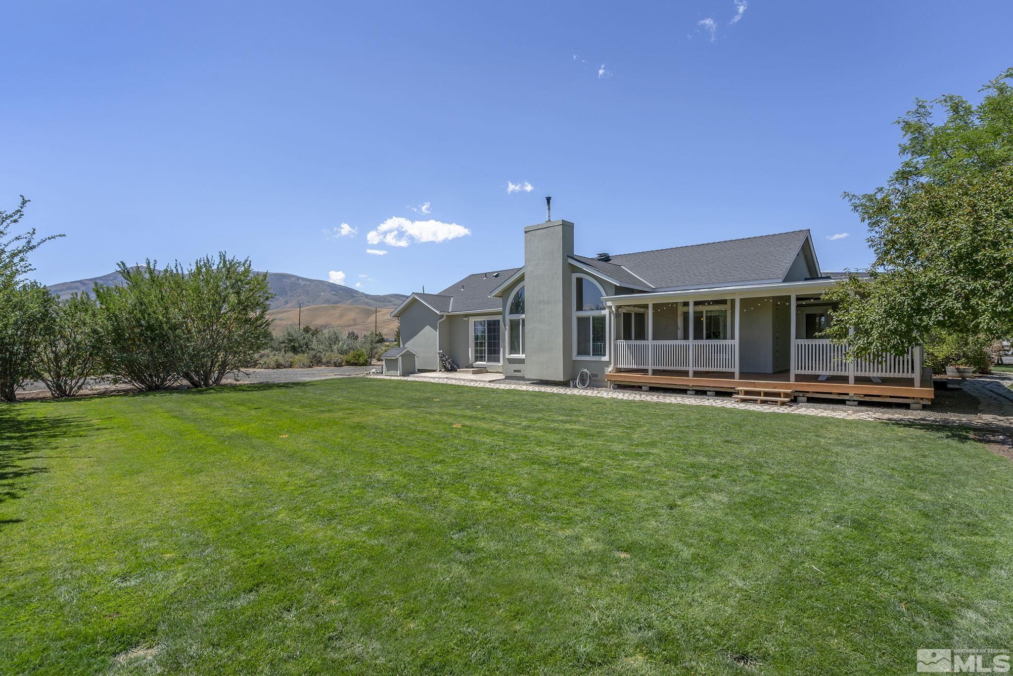 11090 Wagon Ho Lane Reno, NV 89508 - Photo 24 of 33 a front view of a house with a yard table and chairs