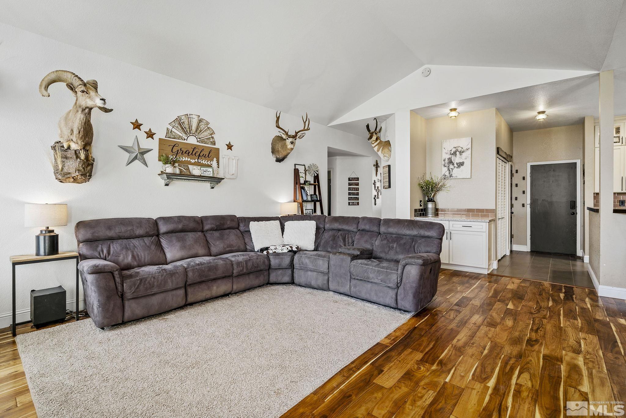 11090 Wagon Ho Lane Reno, NV 89508 - Photo 7 of 33 a living room with couches and kitchen view with wooden floor