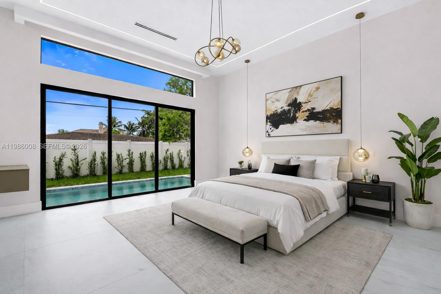 2755 Northeast 31st Court Lighthouse Point, FL 33064 - Photo 11 of 24 a spacious bedroom with a bed and a painting on the wall