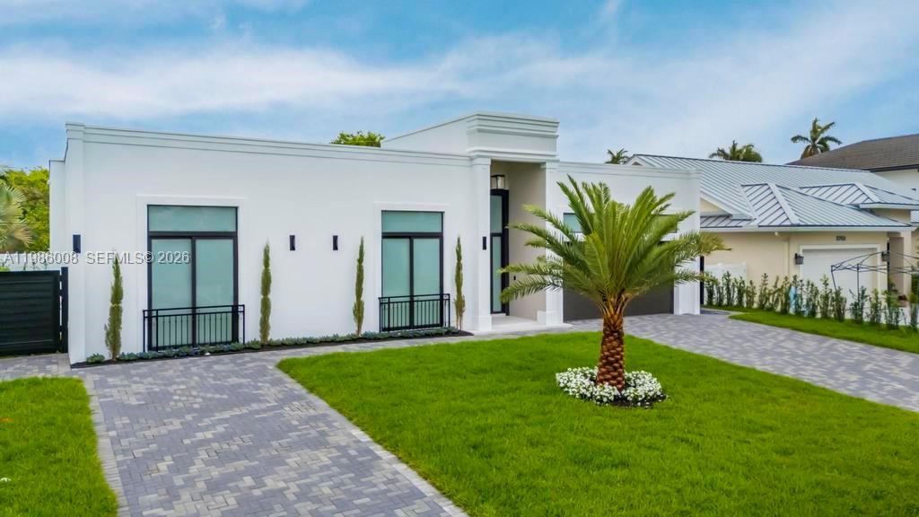 2755 Northeast 31st Court Lighthouse Point, FL 33064 - Photo 20 of 24 a front view of a house with a garden and yard