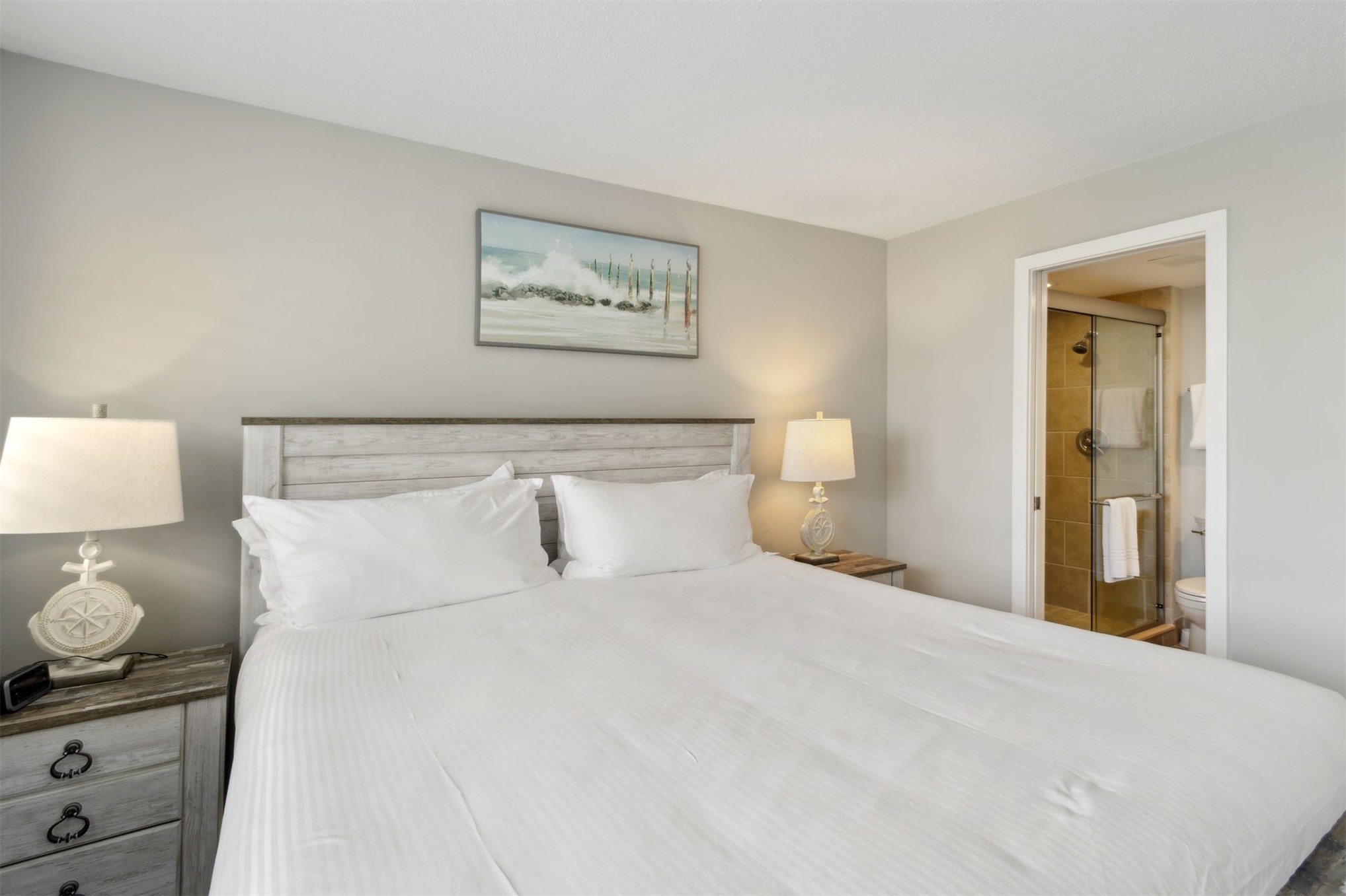 1165 Beach Walker Road, Unit 1165 Fernandina Beach, FL 32034 - Photo 25 of 45 a bedroom with a bed and a lamp on dresser