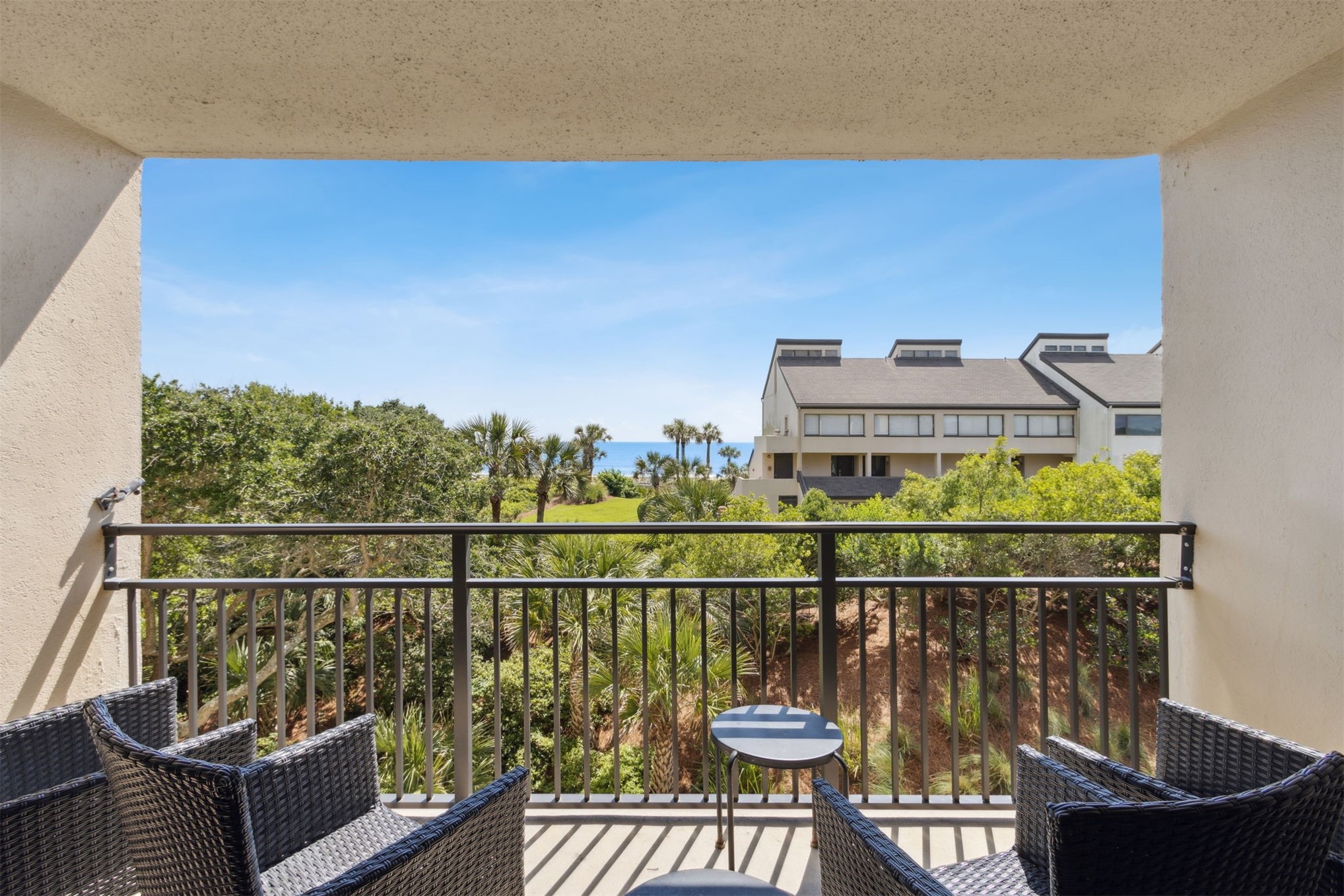1165 Beach Walker Road, Unit 1165 Fernandina Beach, FL 32034 - Photo 4 of 45 a view of a balcony with two chairs and a potted plant