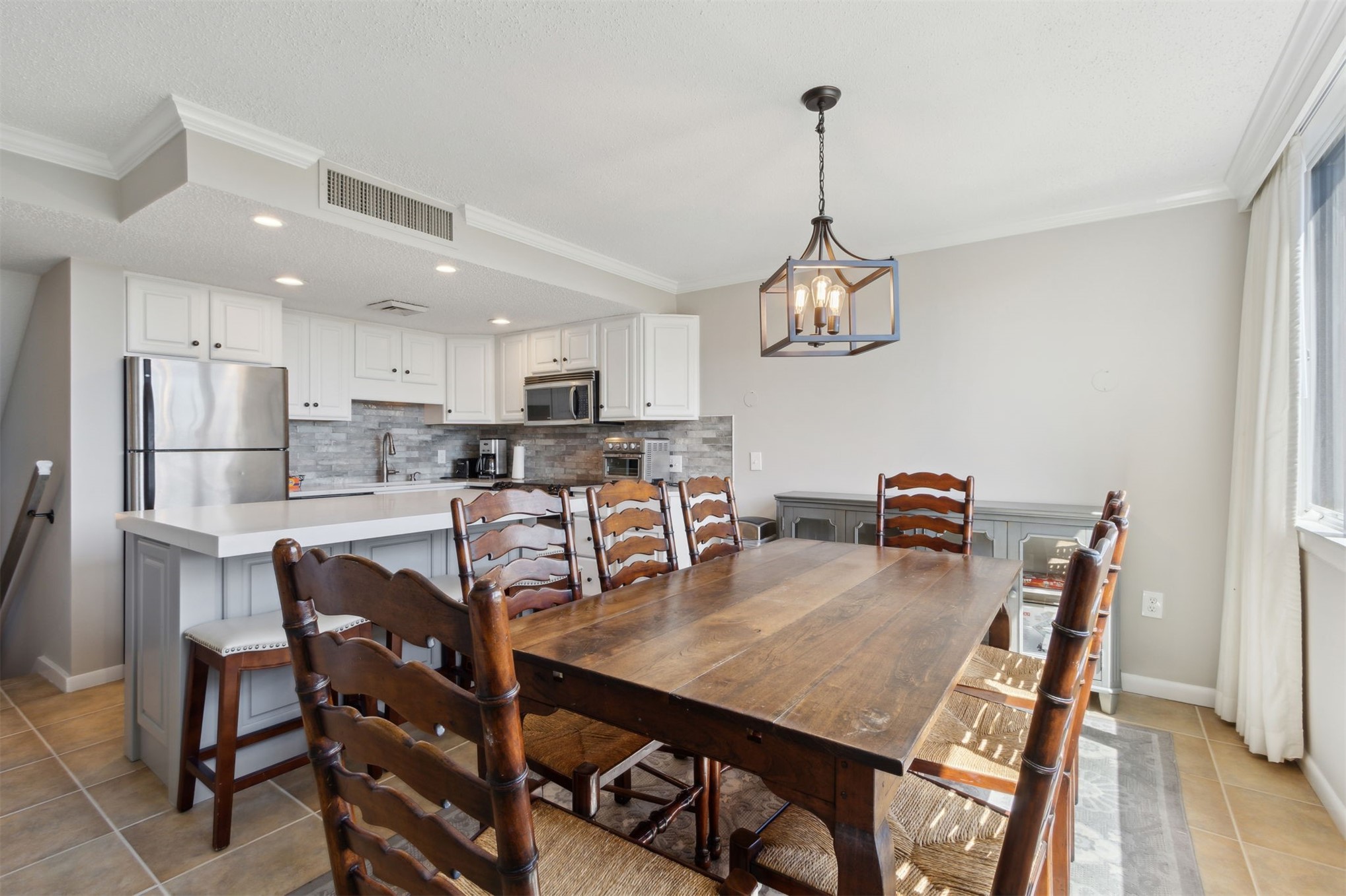 1165 Beach Walker Road, Unit 1165 Fernandina Beach, FL 32034 - Photo 10 of 45 a view of a dining room and livingroom with furniture wooden floor a rug a chandelier