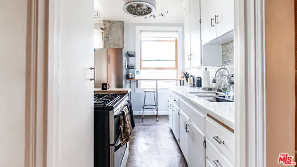 a kitchen with a sink stove and refrigerator