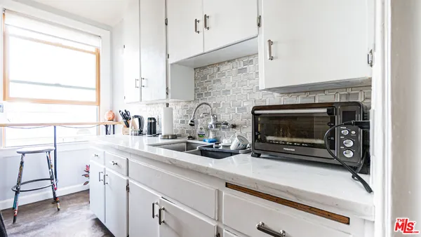 a kitchen with appliances a sink and a counter