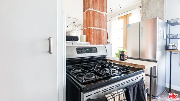 a kitchen with stainless steel appliances granite countertop a stove and a microwave