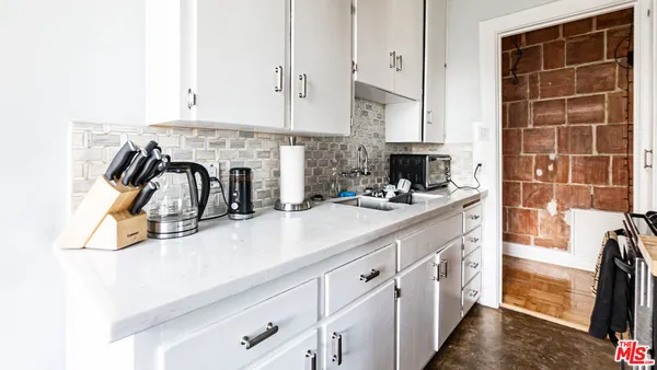 a kitchen with stainless steel appliances a sink and cabinets