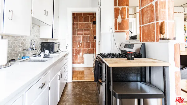 a kitchen with a stove a sink and a refrigerator