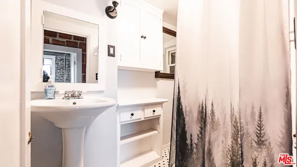 a bathroom with a sink a mirror and a window