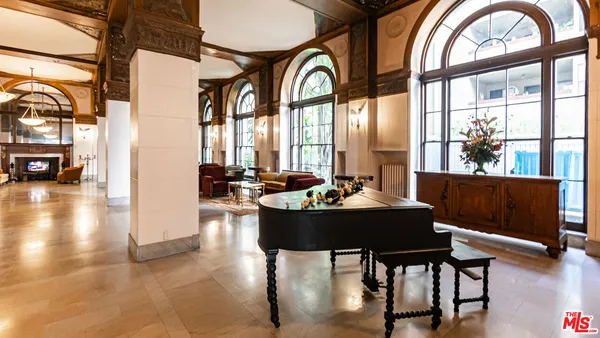 a dining room with furniture a fireplace and wooden floor
