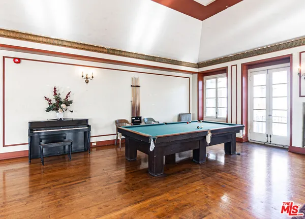 a view of a livingroom with hardwood floor and a large window