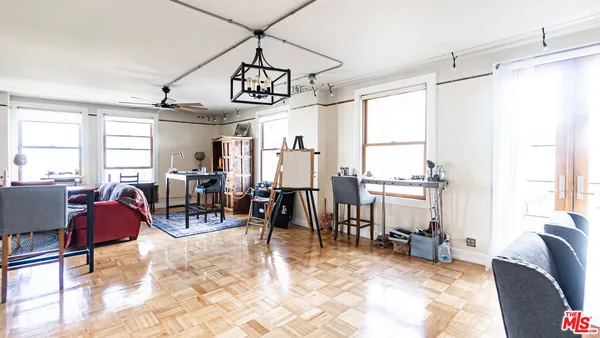 a view of a livingroom with furniture a rug a rug and windows
