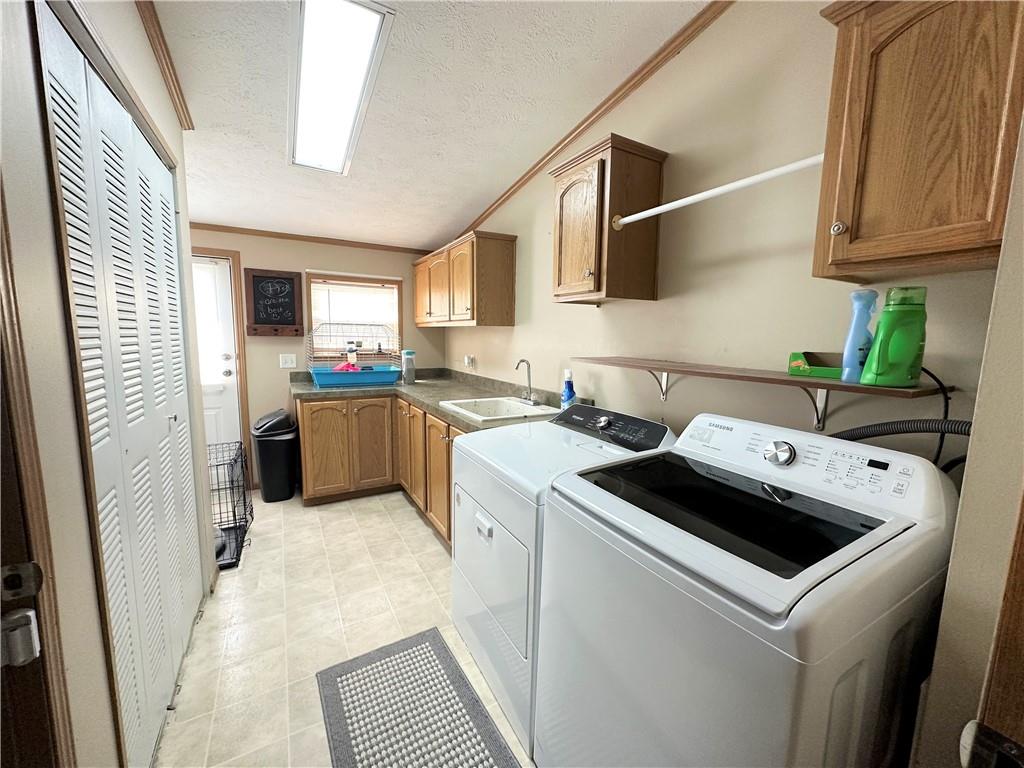167 Poplar Road Avella, PA 15312 - Photo 24 of 34 a kitchen with a stove sink and cabinets