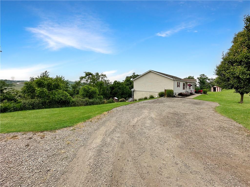 167 Poplar Road Avella, PA 15312 - Photo 3 of 34 a view of a house with a yard and garage