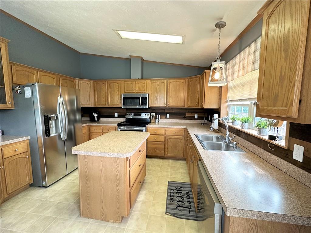 167 Poplar Road Avella, PA 15312 - Photo 6 of 34 a view of a kitchen with kitchen island a large window cabinets a sink and stainless steel appliances