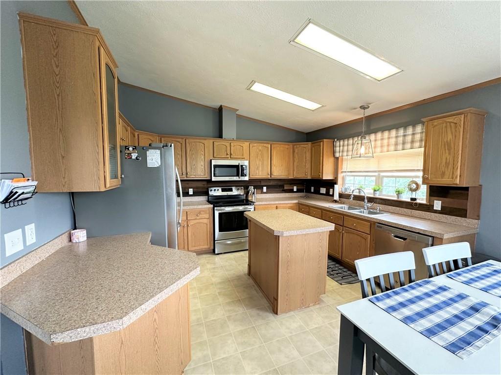 167 Poplar Road Avella, PA 15312 - Photo 7 of 34 a kitchen with stainless steel appliances granite countertop a stove a sink a refrigerator and a cabinets