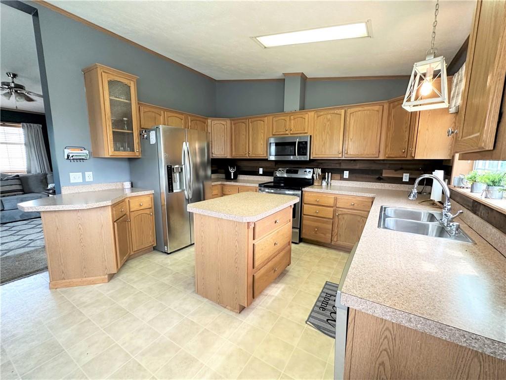 167 Poplar Road Avella, PA 15312 - Photo 8 of 34 a kitchen with a stove a sink a microwave a counter top space and cabinets