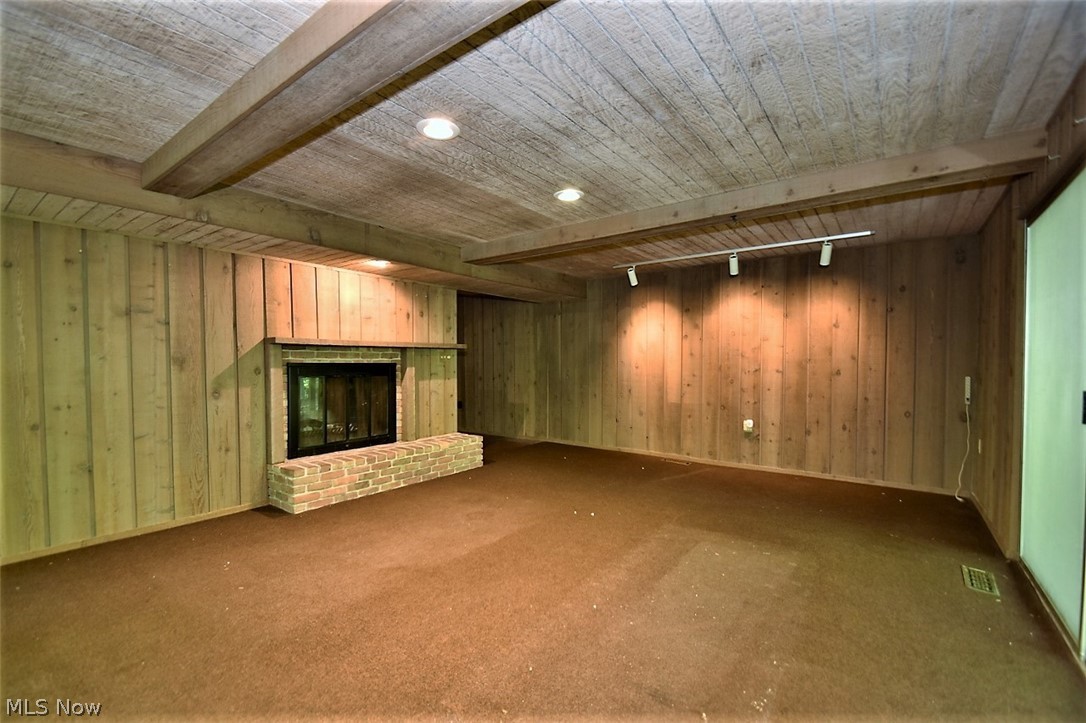4152 Giles Road Chagrin Falls, OH 44022 - Photo 22 of 31 Lower level family room with fireplace, paneling and paneled ceiling