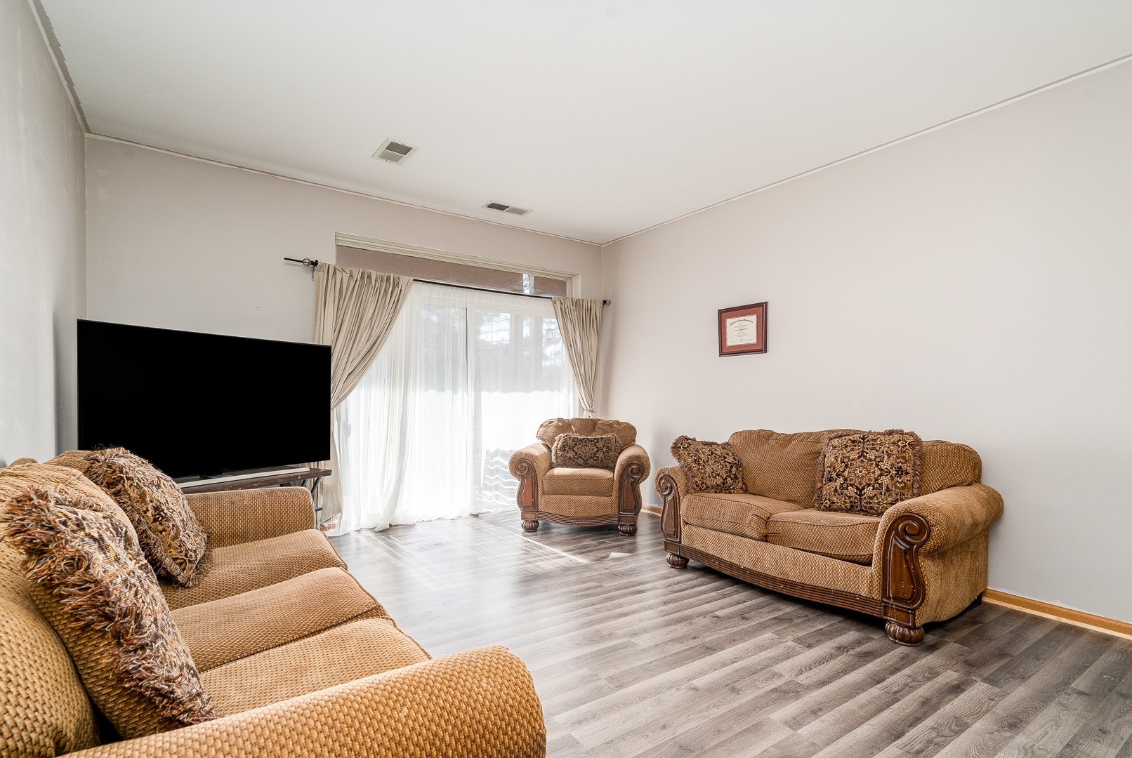 24100 Pear Tree Circle Plainfield, IL 60585 - Photo 5 of 13 a living room with furniture and a flat screen tv