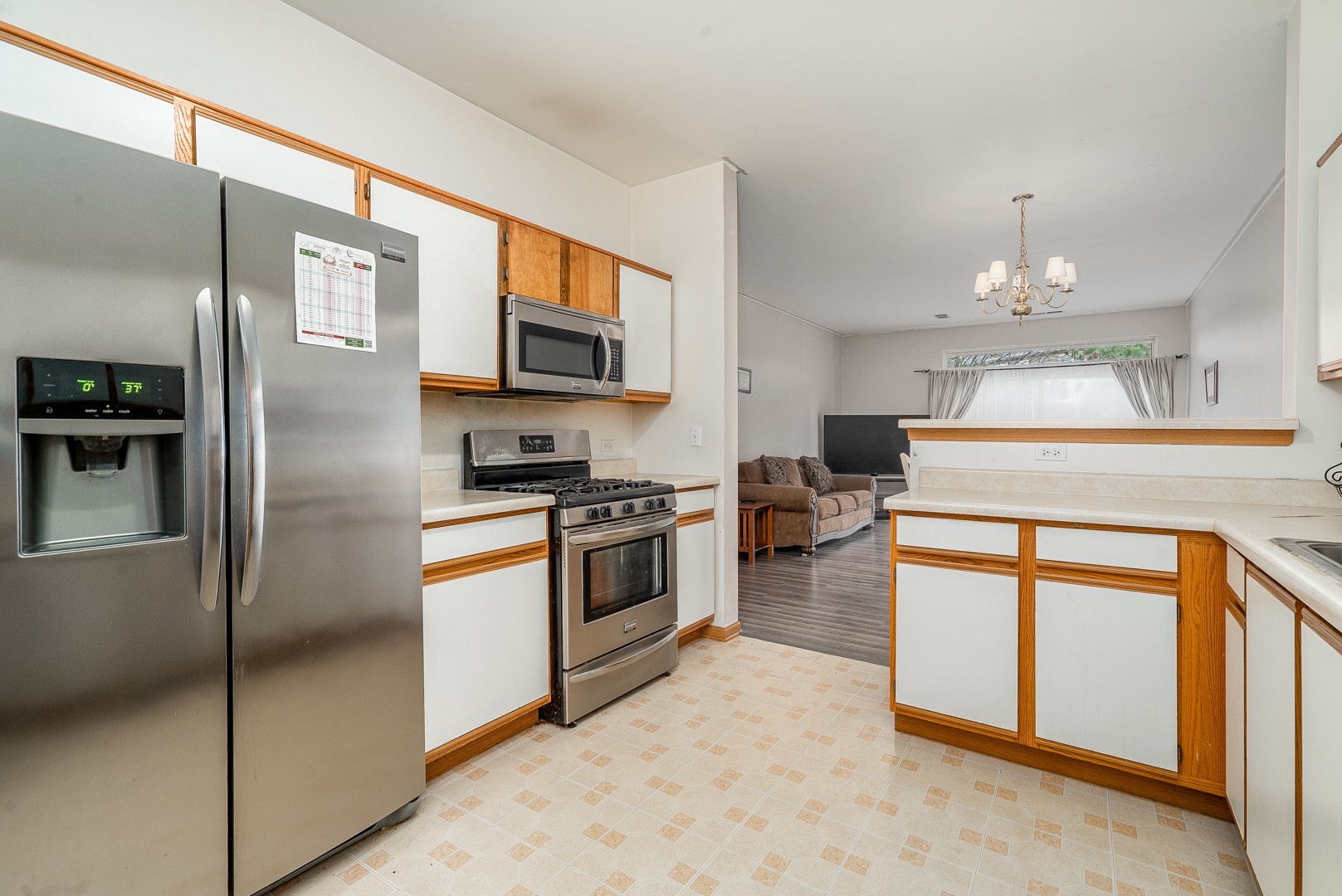 24100 Pear Tree Circle Plainfield, IL 60585 - Photo 6 of 13 a kitchen with stainless steel appliances granite countertop a refrigerator a stove and a sink