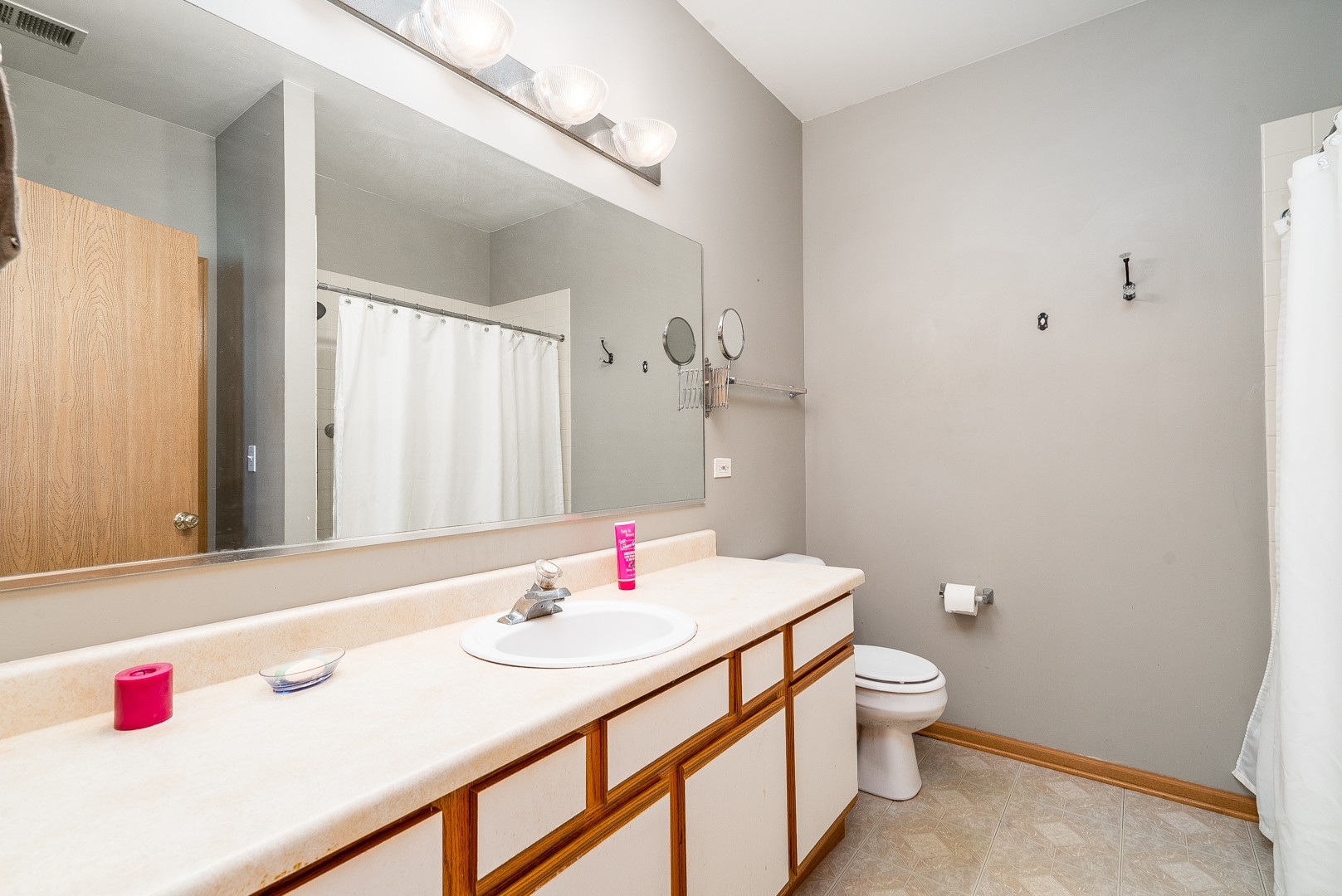 24100 Pear Tree Circle Plainfield, IL 60585 - Photo 9 of 13 a bathroom with a sink and a mirror