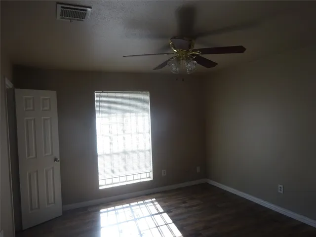 a bathroom with a toilet and a mirror