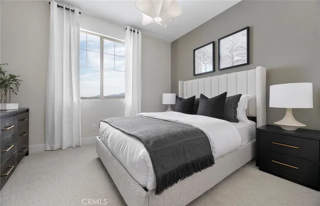 a bedroom with a bed and a night stand