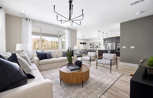 a living room with furniture and a chandelier