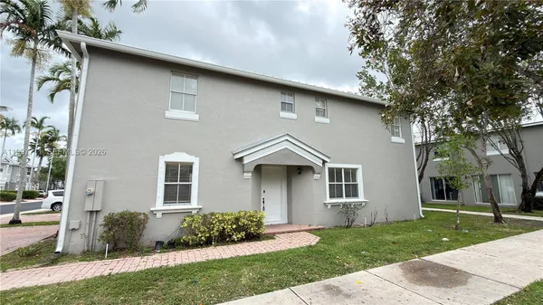a front view of a house with many windows