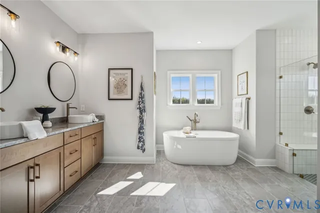 a spacious bathroom with a double vanity sink mirror and a bathtub