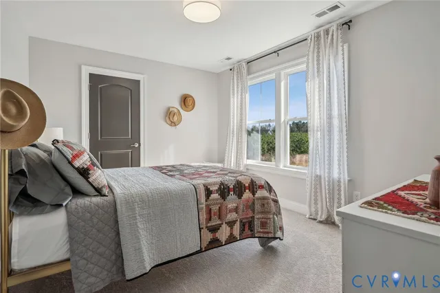 a bed sitting in a bedroom next to a window