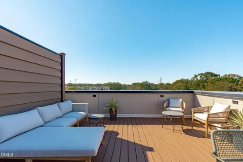 a view of a terrace with couches and wooden floor