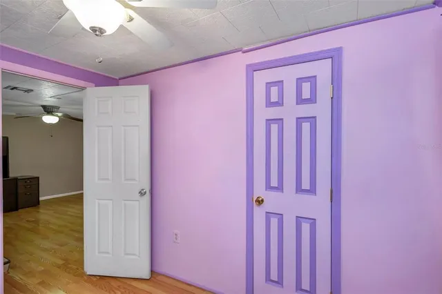 a room with walk in closet and wooden floor