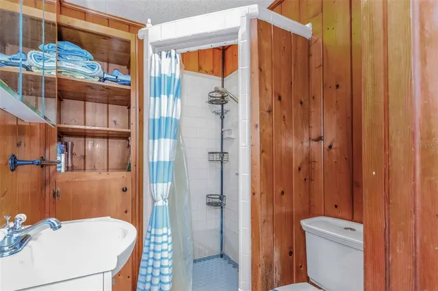 a bedroom with bed and a chandelier