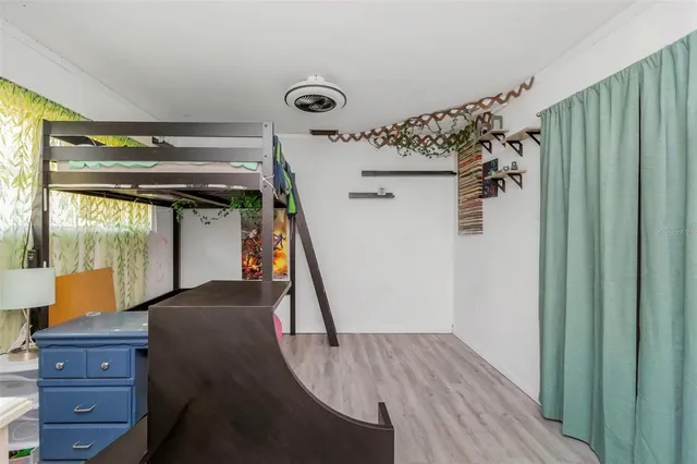 a view of a house with backyard and a tree