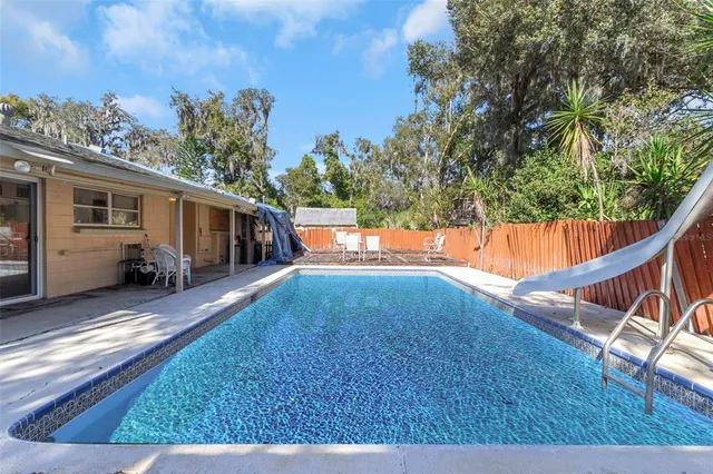 a backyard of a house with table and chairs