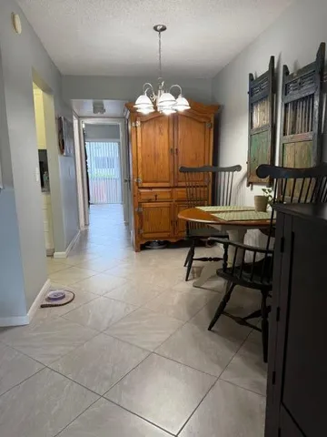 a room with furniture a piano and a chandelier