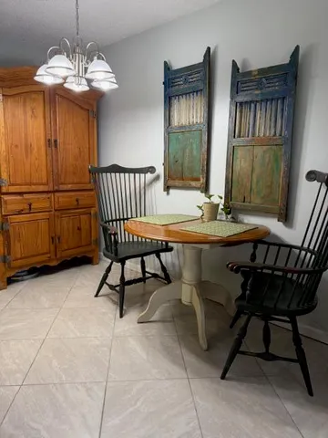 a dining room with a wooden table and chairs