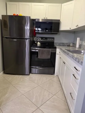 a kitchen with a stove a refrigerator and a sink