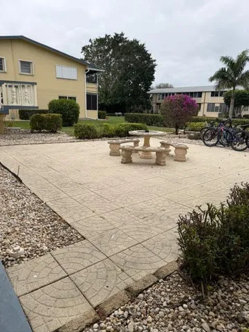 a view of swimming pool with outdoor seating and plants