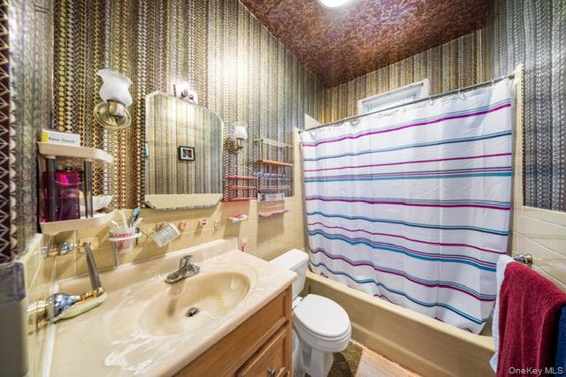 41-71 Gleane Street Queens, NY 11373 - Photo 14 of 28 a bathroom with a sink and a mirror