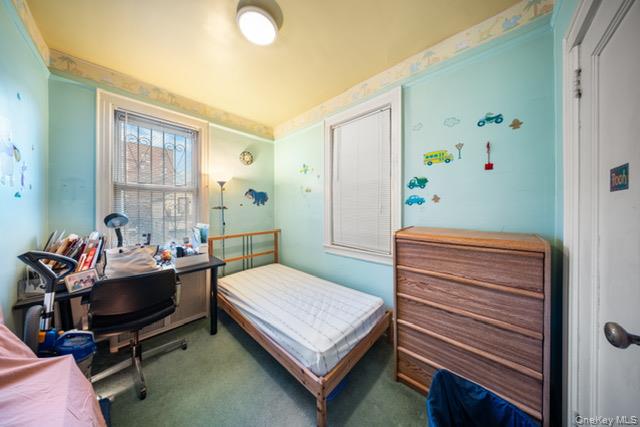 41-71 Gleane Street Queens, NY 11373 - Photo 15 of 28 a bedroom with a bed and a window