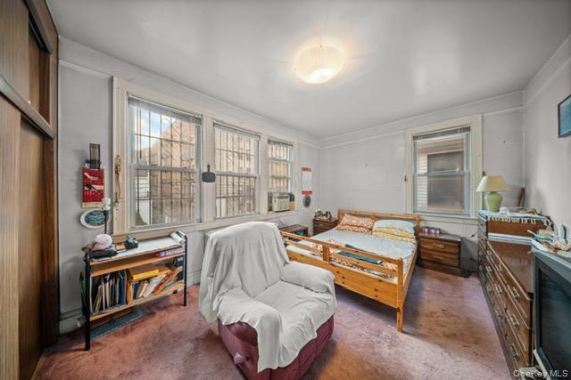 41-71 Gleane Street Queens, NY 11373 - Photo 17 of 28 a bedroom with furniture and a window