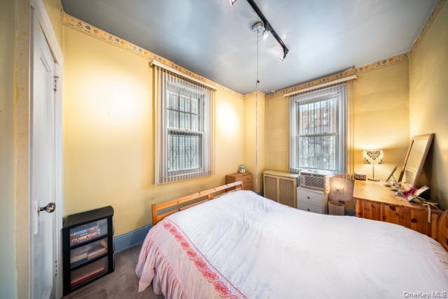 41-71 Gleane Street Queens, NY 11373 - Photo 21 of 28 a bedroom with a bed and a large window