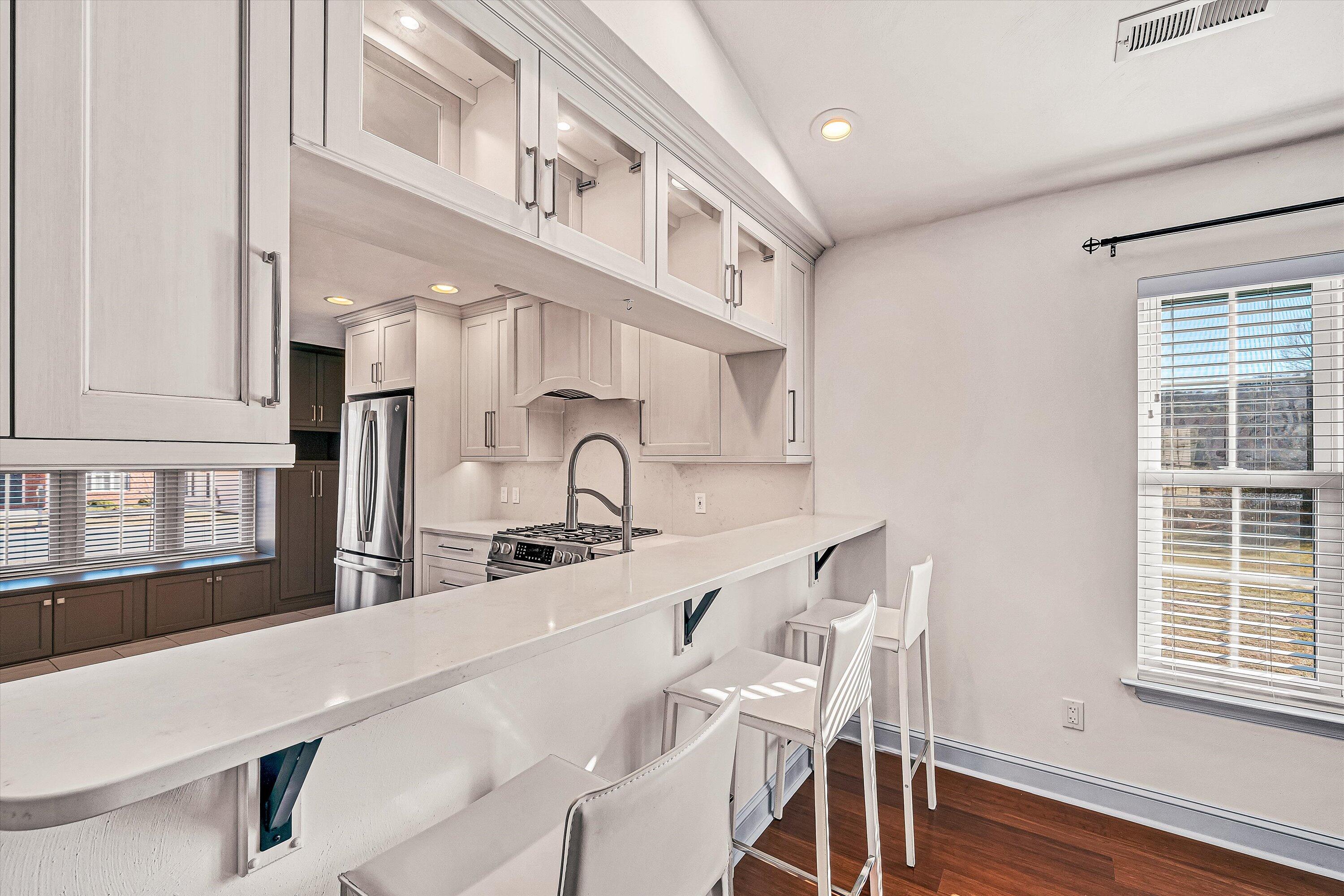 4530 Colonial Pl Drive Roanoke, VA 24018 - Photo 11 of 39 a kitchen with stainless steel appliances a table chairs in it and wooden floors