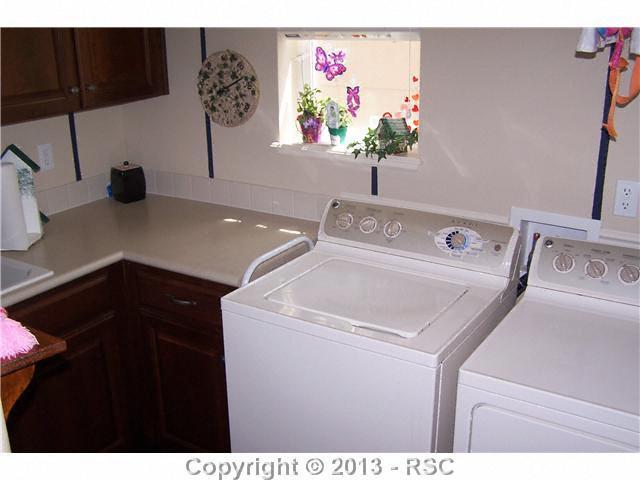 812 Spectrum Loop Colorado Springs, CO 80921 - Photo 10 of 17 Great sized laundry room with counter & cabinet space and deep soaking sink.
