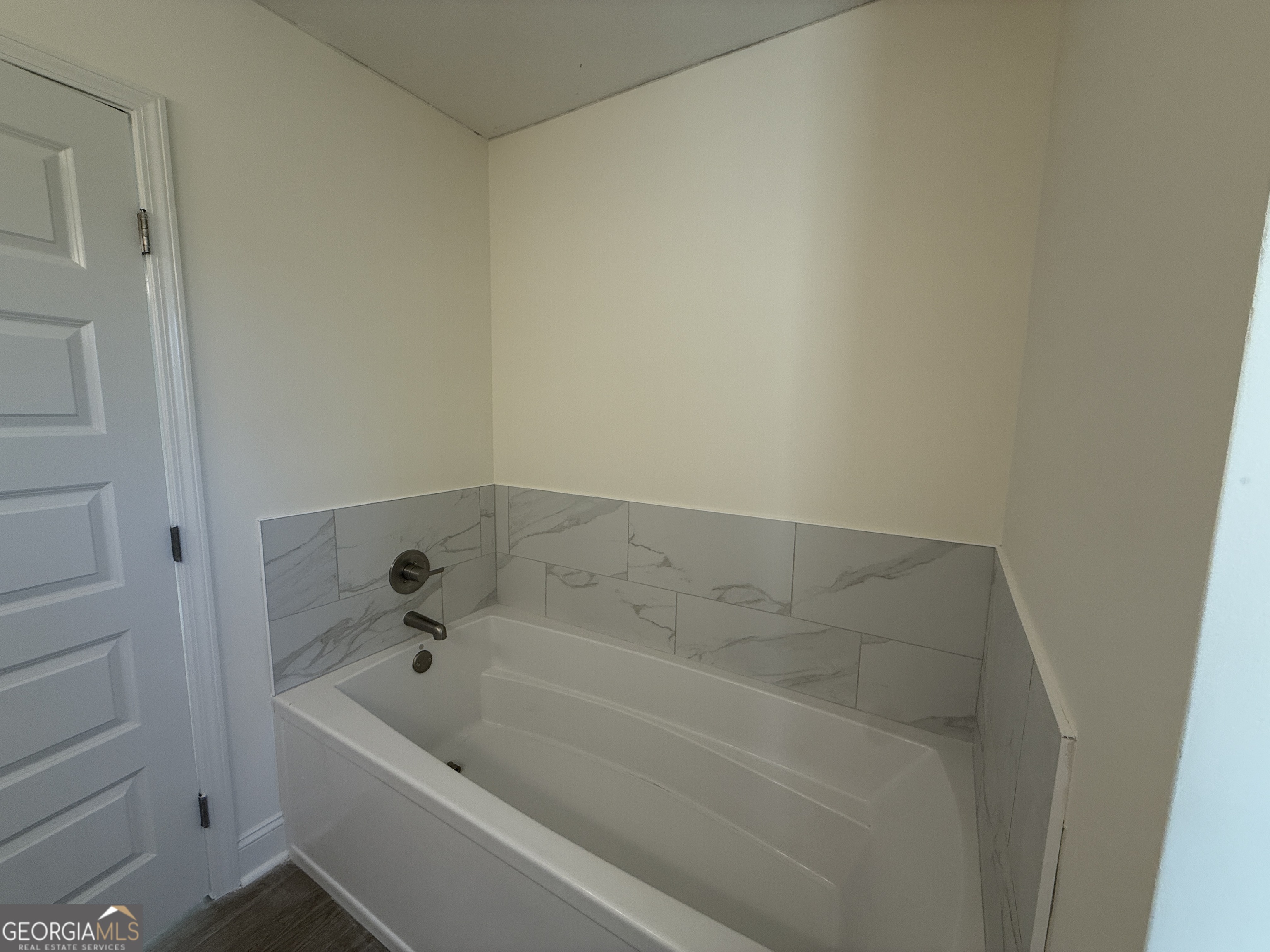 304 Womack Road South Portal, GA 30450 - Photo 13 of 19 a bathroom with a bathtub